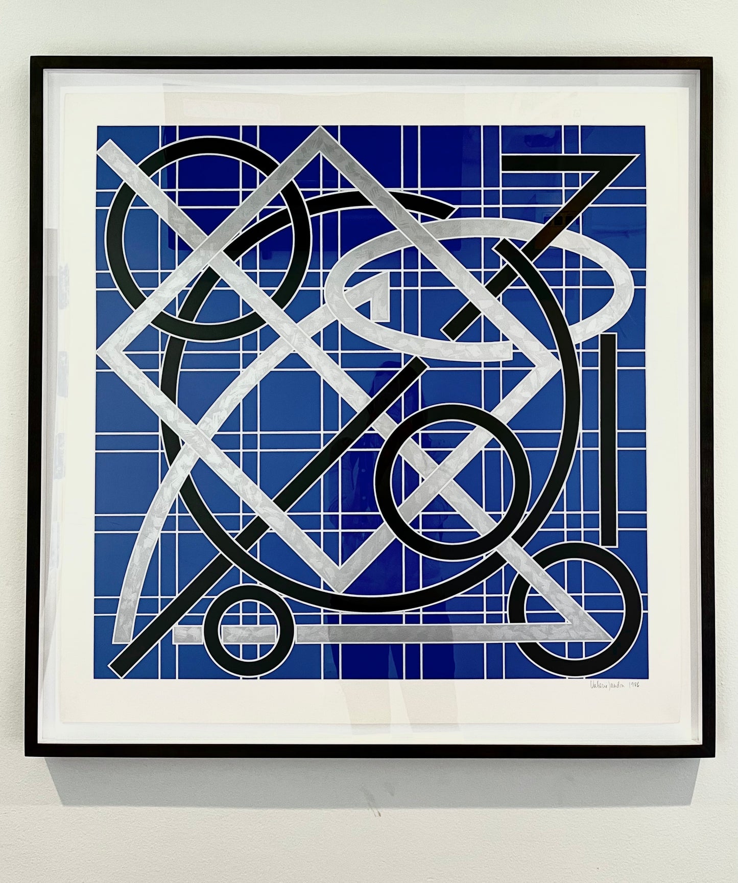 “Untitled” by Valerie Jaudon in a black frame on a white wall.
