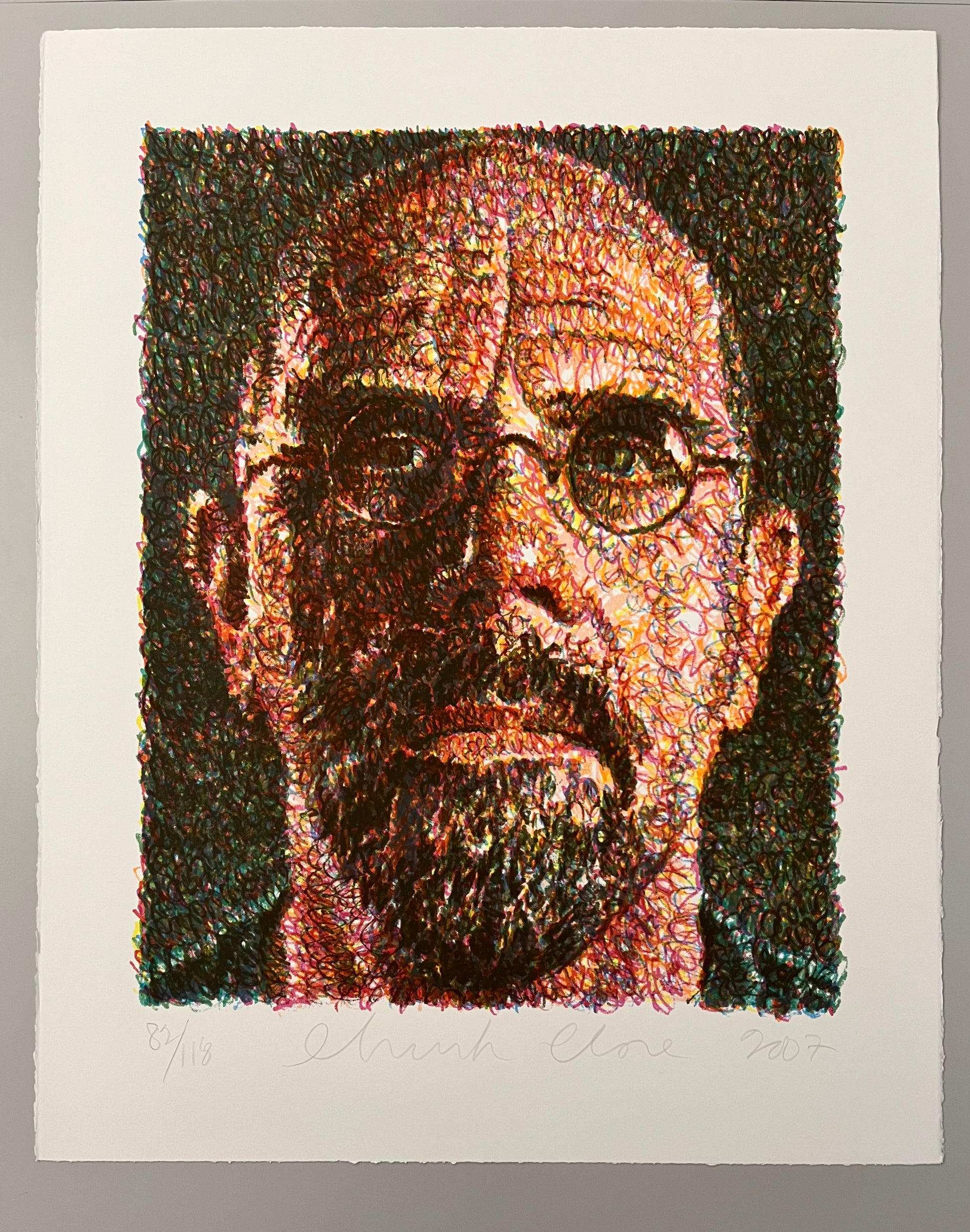 "Self Portrait" by Chuck Close, A highly detailed portrait of a man with glasses, created using intricate, colorful swirling lines. The abstract style emphasizes texture and depth, giving the image a vibrant, dynamic appearance. 
