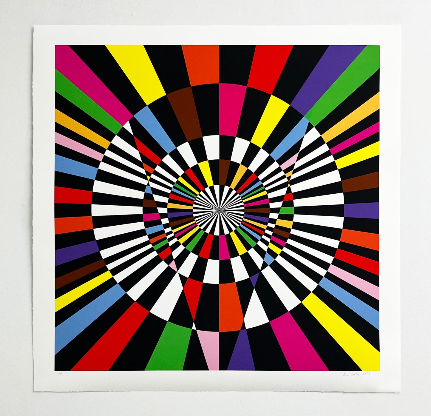 “Untitled (Collective Light Power), 2023” by Rico Gatson, Vibrant artwork featuring concentric circles with alternating black and white stripes at the center. Surrounding them, colorful triangular segments radiate outward, creating a dynamic, hypnotic effect. 